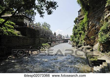 Stock Photograph - Pandra Shivalaya Complex and the Ghats of Pashupatinath on the holy Bagmati River, Kathmandu, Nepal, Asia. Fotosearch