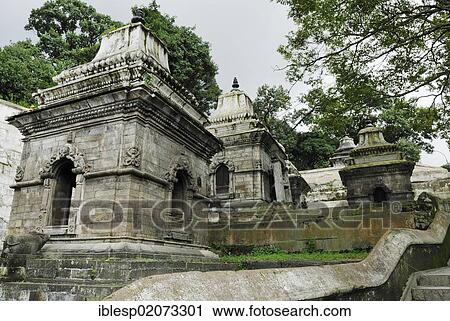 Stock Image - Pandra Shivalaya Complex, temple complex of Pashupatinath on the sacred Bagmati River, Kathmandu, Nepal, Asia. Fotosearch