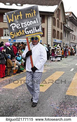 Parade participant carrying a sign lettering "Wirt mit Personal sucht Gasthof", German for "publican and staff looking for a pub", 35th Motteri-Umzug parade in Malters, Lucerne, Switzerland, Europe View Large Photo Image Stock Photography - Parade participant carrying a sign lettering "Wirt mit Personal sucht Gasthof", German for "publican and staff looking for a pub", 35th Motteri-Umzug parade in Malters, Lucerne, Switzerland, Europe. Fotosearch