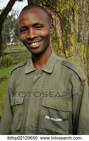 Stock Image - Park guide at the entrance to the Volcanoes National Park, Parc National des Volcans near the village of Kinigi, Rwanda, Africa. Fotosearch