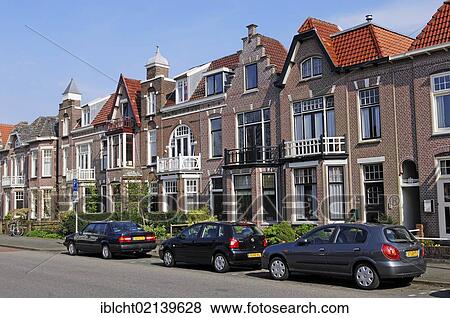 Parked cars in front of a row of houses, Alkmaar, North Holland, Holland, Netherlands, Europe View Large Photo Image Stock Photo - Parked cars in front of a row of houses, Alkmaar, North Holland, Holland, Netherlands, Europe. Fotosearch