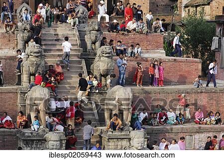 Stock Image - People on the steps of the Nyatapola Pagoda, Taumadhi square, Bhaktapur, Kathmandu Valley, Nepal, Asia. Fotosearch