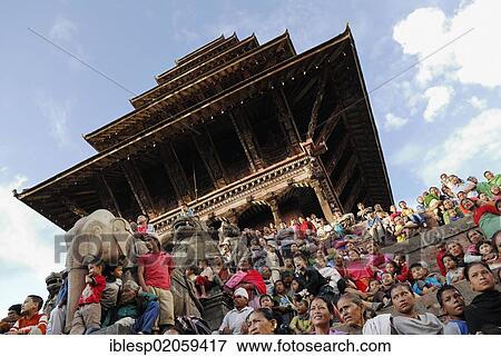 Stock Photo - People watching a procession, steps of the Nyatapola Pagoda, Taumadhi Square, Bhaktapur, Kathmandu Valley, Nepal, Asia. Fotosearch