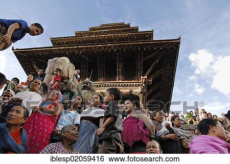 Stock Photograph - People watching a procession, steps of the Nyatapola Pagoda, Taumadhi Square, Bhaktapur, Kathmandu Valley, Nepal, Asia. Fotosearch