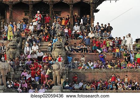 Stock Photograph - People watching procession, steps of the Nyatapola Pagoda, Taumadhi square, Bhaktapur, Kathmandu Valley, Nepal, Asia. Fotosearch