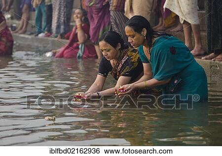 Stock Photograph - Pilgrims at the ghats of Varanasi in the busy morning hours, Uttar Pradesh, India, Asia. Fotosearch