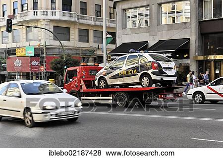 Stock Photo - Policia, police car on a tow truck, city centre, Madrid, Spain, Europe. Fotosearch