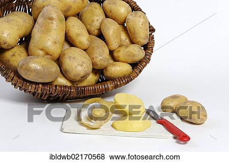 Stock Photo - Potato peeling, peeled raw potatoes. Fotosearch