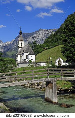 Stock Image - Ramsauer Ache and the Parish Church of St. Fabian and St. Sebastian, Ramsau, Berchtesgadener Land, Bavaria, Germany, Europe. Fotosearch