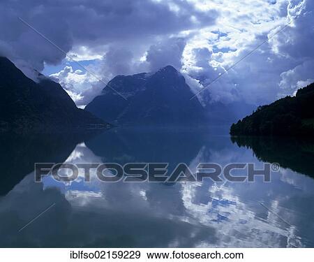 Reflection and a cloudy mood at Lake Strynsvatn, Strynevatnet, near Stryn, Sogn og Fjordane, Norway, Scandinavia, Europe View Large Photo Image Stock Photo - Reflection and a cloudy mood at Lake Strynsvatn, Strynevatnet, near Stryn, Sogn og Fjordane, Norway, Scandinavia, Europe. Fotosearch