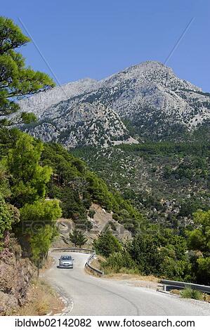 Stock Image - Road on the west coast, with Mount Kerkis, Samos Island, Aegean Sea, southern Sporades islands, Greece, Europe. Fotosearch