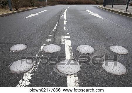 Road with directional arrows and speed bumps to reduce speed, Oberhausen, Ruhr Area, North Rhine-Westphalia, Germany, Europe View Large Photo Image Stock Photograph - Road with directional arrows and speed bumps to reduce speed, Oberhausen, Ruhr Area, North Rhine-Westphalia, Germany, Europe. Fotosearch