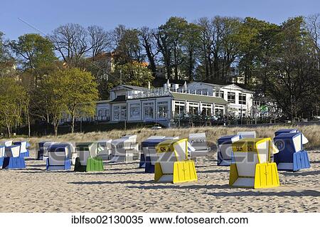 Roofed wicker beach chairs on a beach near Goehren, looking towards the Panorama beach cafe, Ruegen, Mecklenburg-Western Pomerania, Germany, Europe View Large Photo Image Stock Photography - Roofed wicker beach chairs on a beach near Goehren, looking towards the Panorama beach cafe, Ruegen, Mecklenburg-Western Pomerania, Germany, Europe. Fotosearch