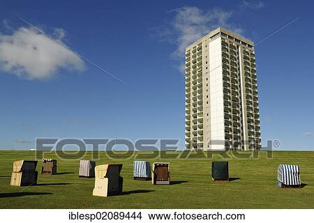 Roofed wicker beach chairs standing on the lawn in front of a skyscraper, Buesum, district of Dithmarschen, Schleswig-Holstein, North Sea, Wadden Sea, Germany, Europe, PublicGround, Europe View Large Photo Image Picture - Roofed wicker beach chairs standing on the lawn in front of a skyscraper, Buesum, district of Dithmarschen, Schleswig-Holstein, North Sea, Wadden Sea, Germany, Europe, PublicGround, Europe. Fotosearch