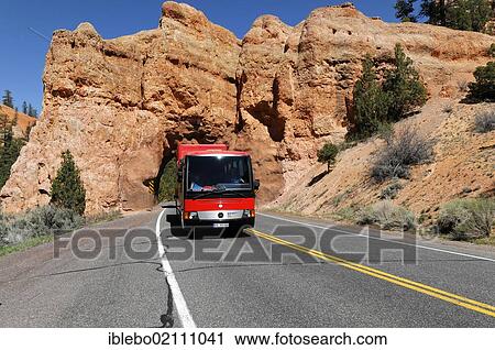 Stock Image - Rotelbus, rolling hotel on the road, tunnel through Red Canyon on Highway 12, Panguitch, Utah, USA, North America. Fotosearch