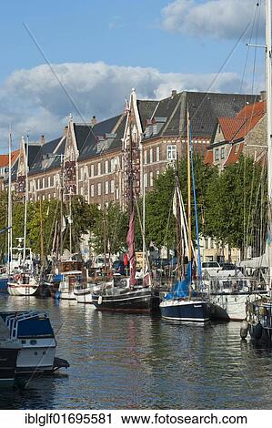 Row of houses on the canal port in Fristad Christiania or free city Christiania, Copenhagen, Denmark, Europe View Large Photo Image Stock Image - Row of houses on the canal port in Fristad Christiania or free city Christiania, Copenhagen, Denmark, Europe. Fotosearch