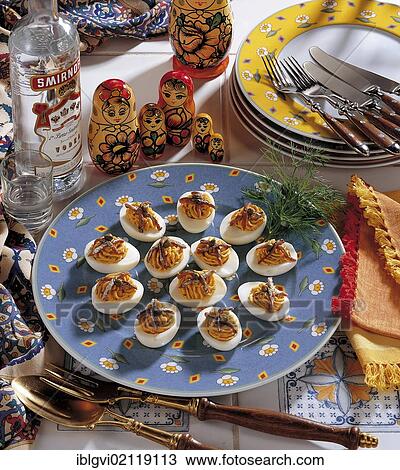 Stock Image - Russian eggs, with spicy mayonnaise filling, garnished with anchovies, cold starter, Russia, Europe. Fotosearch