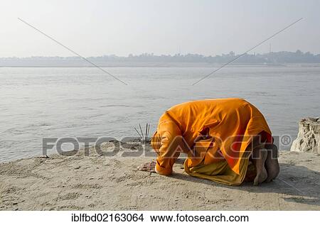 Sadhu, holy man, praying at Sangam, the confluence of the holy rivers Ganges, Yamuna and Saraswati, in Allahabad, Uttar Pradesh, India, Asia View Large Photo Image Picture - Sadhu, holy man, praying at Sangam, the confluence of the holy rivers Ganges, Yamuna and Saraswati, in Allahabad, Uttar Pradesh, India, Asia. Fotosearch