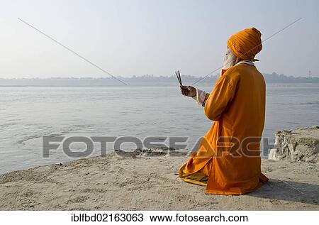 Sadhu, holy man, praying at Sangam, the confluence of the holy rivers Ganges, Yamuna and Saraswati, in Allahabad, Uttar Pradesh, India, Asia View Large Photo Image Stock Image - Sadhu, holy man, praying at Sangam, the confluence of the holy rivers Ganges, Yamuna and Saraswati, in Allahabad, Uttar Pradesh, India, Asia. Fotosearch