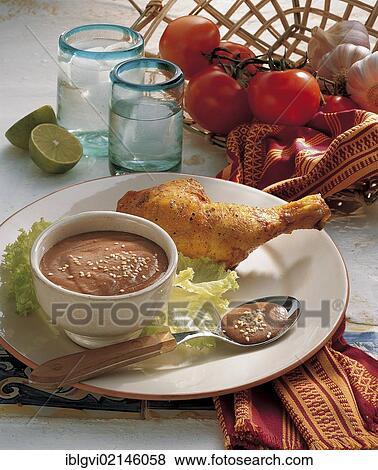 Stock Photo - Savoury chocolate sauce, with tomatoes, chilli, plantain, ground almonds and raisins, Mexico, North America. Fotosearch