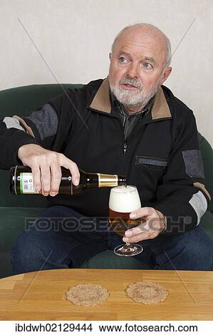 Senior man pouring a beer View Large Photo Image Picture - Senior man pouring a beer. Fotosearch