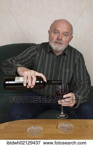 Senior man pouring wine View Large Photo Image Stock Photo - Senior man pouring wine. Fotosearch