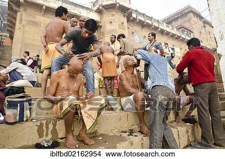 Shaving head and beard is part of the ritual to bid farewell to the soul of a deceased person, at the ghats of Varanasi, Uttar Pradesh, India, Asia View Large Photo Image Picture - Shaving head and beard is part of the ritual to bid farewell to the soul of a deceased person, at the ghats of Varanasi, Uttar Pradesh, India, Asia. Fotosearch