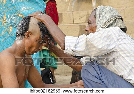 Shaving head and beard is part of the ritual to bid farewell to the soul of a deceased person, at the ghats of Varanasi, Uttar Pradesh, India, Asia View Large Photo Image Stock Photo - Shaving head and beard is part of the ritual to bid farewell to the soul of a deceased person, at the ghats of Varanasi, Uttar Pradesh, India, Asia. Fotosearch
