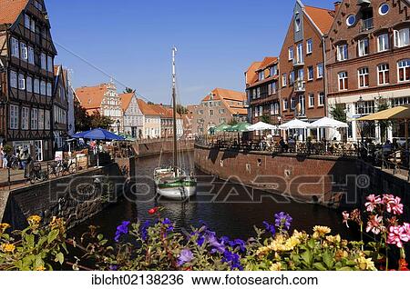 Stock Photograph - Ship in the old harbour and outdoor cafes, Stade, Lower Saxony, Germany, Europe. Fotosearch