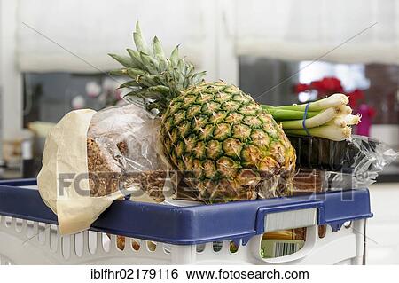 Shopping basket full of food in a kitchen View Large Photo Image Stock Photograph - Shopping basket full of food in a kitchen. Fotosearch