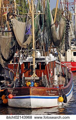 Stock Photo - Shrimp cutters in the harbour, Greetsiel, East Frisia, Lower Saxony, Germany, Europe. Fotosearch