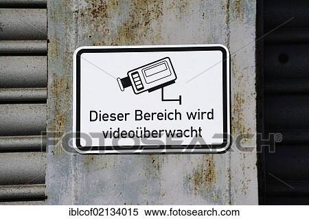 Stock Photography - Sign "Dieser Bereich wird videoueberwacht", German for "this area is under video surveillance", video surveillance. Fotosearch