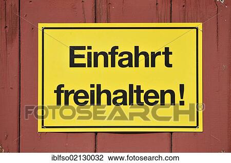 Sign, Einfahrt freihalten! German for Keep entrance clear, yellow on a red wooden gate, Germany, Europe View Large Photo Image Stock Image - Sign, Einfahrt freihalten! German for Keep entrance clear, yellow on a red wooden gate, Germany, Europe. Fotosearch