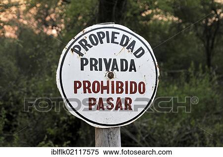 Sign "Propiedad privada, Prohibido pasar", "private property, access prohibited", marking the grounds of a major landowner in the Gran Chaco region, Salta province, Argentina, South America View Large Photo Image Stock Photography - Sign "Propiedad privada, Prohibido pasar", "private property, access prohibited", marking the grounds of a major landowner in the Gran Chaco region, Salta province, Argentina, South America. Fotosearch