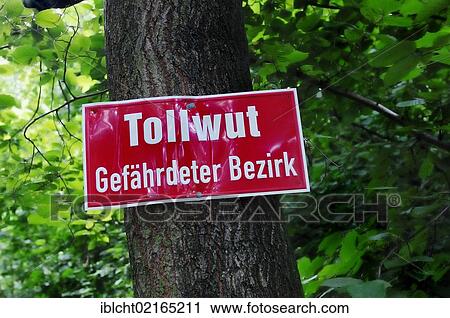 Stock Image - Sign, "Tollwut Gefaehrdeter Bezirk", German for "Rabies Endangered district", North Rhine-Westphalia, Germany, Europe. Fotosearch