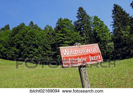 Picture - Sign, Wildtollwut Gefaehrdeter Bezirk, German for Lyssavirus endangered district, Berchtesgaden, Bavaria, Germany, Europe, PublicGround, Europe. Fotosearch