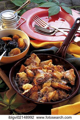 Stock Image - Sliced pancake with dried fruit compote, Switzerland, Europe. Fotosearch