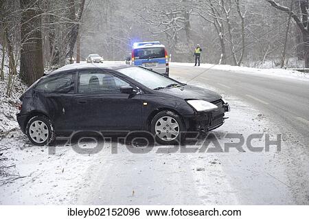 Stock Photograph - Small car after skidding on a slope in the snow on the Mittleren Filderstrasse road heading towards Plieningen, Stuttgart, Baden-Wuerttemberg, Germany, Europe. Fotosearch