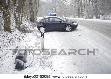 Stock Photography - Small car after skidding on a slope in the snow on the Mittlere Filderstrasse road heading towards Plieningen, Stuttgart, Baden-Wuerttemberg, Germany, Europe. Fotosearch