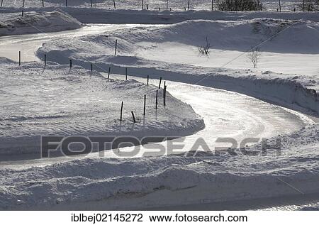 Stock Image - Snow and icy road in Cezallier, Auvergne, France, Europe. Fotosearch