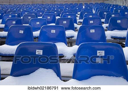 Stock Image - Snow-covered seats, terrace, Muehlenkopfschanze ski jump, Willingen, Waldecker Land region, Upland, Sauerland, Hesse, Germany, Europe. Fotosearch