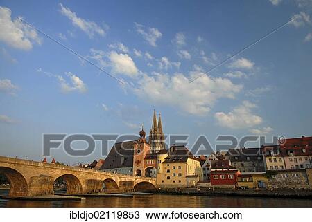 Steinerne Bruecke, Stone Bridge crossing the Danube river and the tower at the southern end of the bridge, the towers of the cathedral at back, Regensburg, Upper Palatinate, Bavaria, Germany, Europe View Large Photo Image Stock Image - Steinerne Bruecke, Stone Bridge crossing the Danube river and the tower at the southern end of the bridge, the towers of the cathedral at back, Regensburg, Upper Palatinate, Bavaria, Germany, Europe. Fotosearch