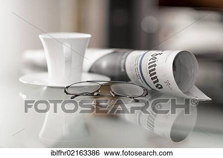 Still life with a daily newspaper, a pair of glasses and a coffee cup View Large Photo Image Stock Photograph - Still life with a daily newspaper, a pair of glasses and a coffee cup. Fotosearch