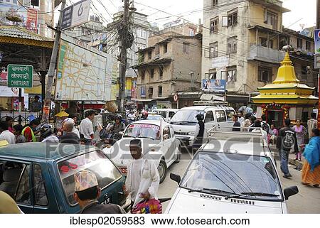 Stock Image - Street scene, dense traffic, pedestrians and cars, junction in the Thamel district, Kathmandu, Nepal, Asia. Fotosearch