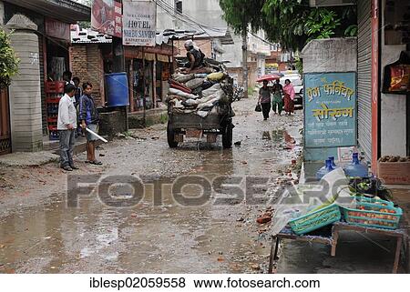 Stock Photo - Street scene, road wet from rain, Kathmandu, Nepal, Asia. Fotosearch