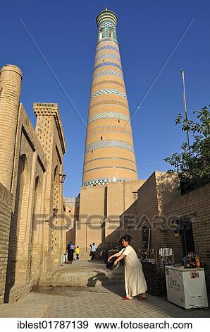 Stock Photo - Streetscape near Islam Khodja or Islom Xoja Minaret in the historic adobe district of Khiva, Chiva, Ichan Kala, Silk Road, Unesco World Heritage Site, Uzbekistan, Central Asia, Asia. Fotosearch