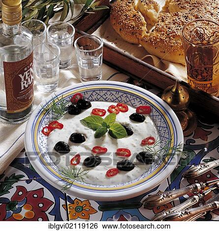 Stock Photograph - Syrian herb yoghurt cream with mint, dill, peppers and olives, cold starter, Syria, Asia. Fotosearch