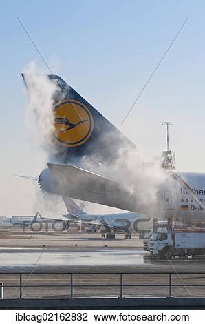 Stock Image - Tail of a Lufthansa Boeing 747-430M being de-iced at Frankfurt Airport, Hesse, Germany, Europe, PublicGround, Europe. Fotosearch