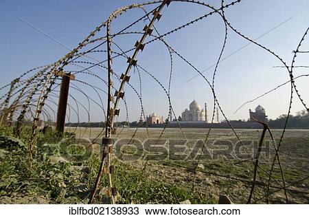 Stock Image - Taj Mahal, UNESCO World Heritage, fenced with barbed wire for security reasons, Agra, Uttar Pradesh, India, Asia. Fotosearch