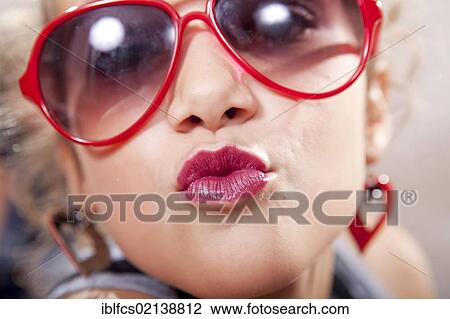 Teenage girl wearing red sunglasses and lipstick View Large Photo Image Stock Image - Teenage girl wearing red sunglasses and lipstick. Fotosearch